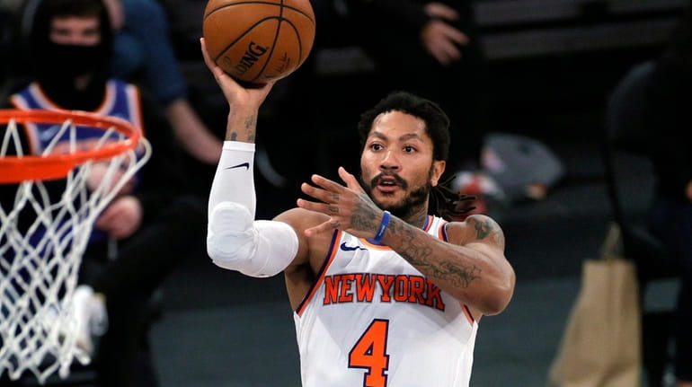 Derrick Rose of the Knicks goes to the basket against the Charlotte...