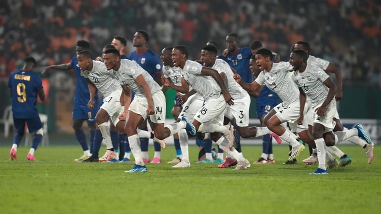 South African players celebrate after winning a penalty shootout at...