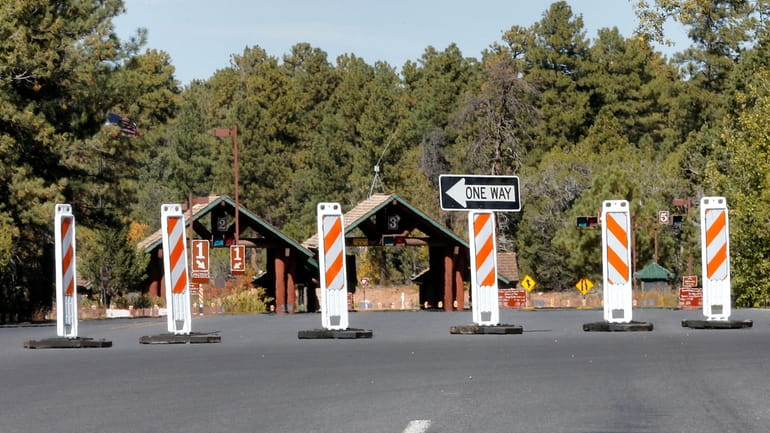 The Grand Canyon National Park entrance is blocked off, in...