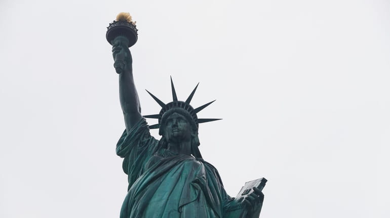 The Statue of Liberty wields her torch on Aug. 14,...