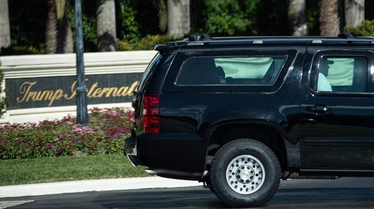 President Donald Trump leaves after playing golf Sunday at his...