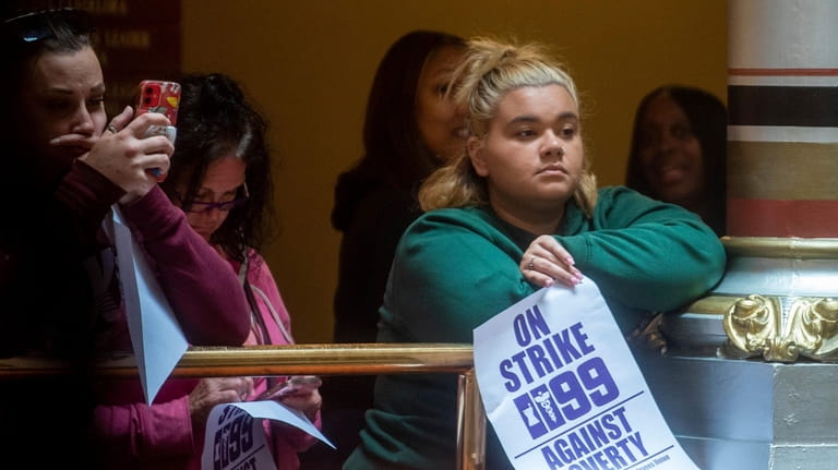 A member of SEIU 1199 protests inside the state Capitol...
