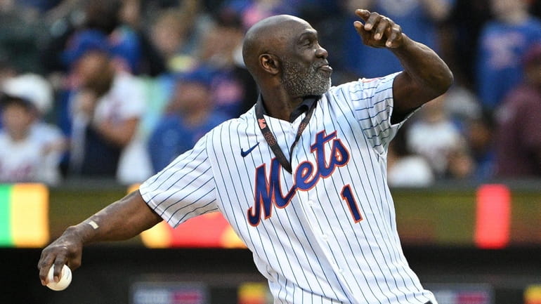 Former Mets player Mookie Wilson delivers a ceremonial first pitch before...