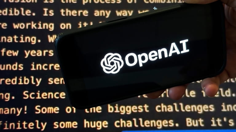 File - The OpenAI logo appears on a mobile phone...