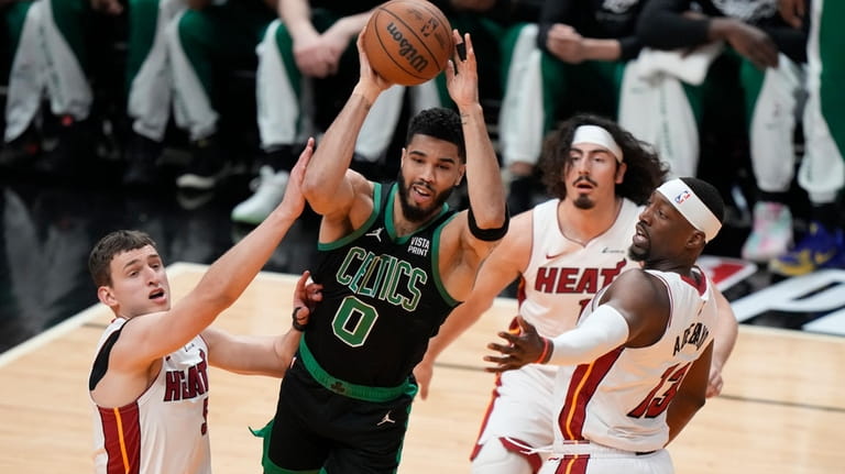 Boston Celtics forward Jayson Tatum (0) passes past Miami Heat...