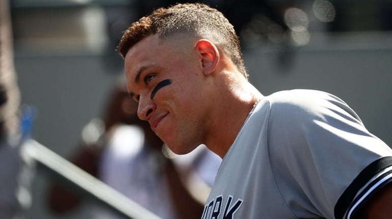 Aaron Judge of the Yankees smiles in the dugout after...