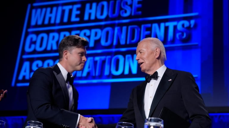 President Joe Biden, right, introduces host Colin Jost at the...
