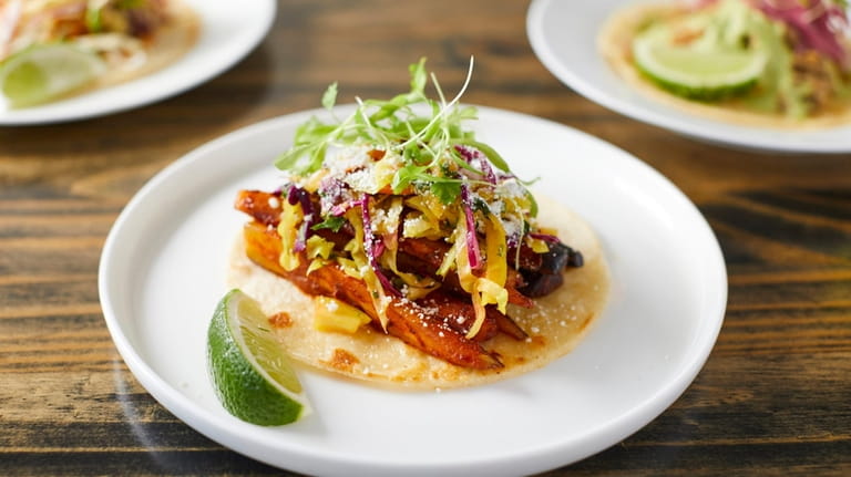 A roasted rainbow carrot taco with al pastor sauce, curtido and...