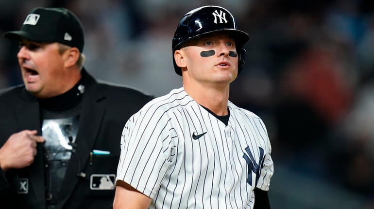 The Yankees' Josh Donaldson reacts as he walks to first...