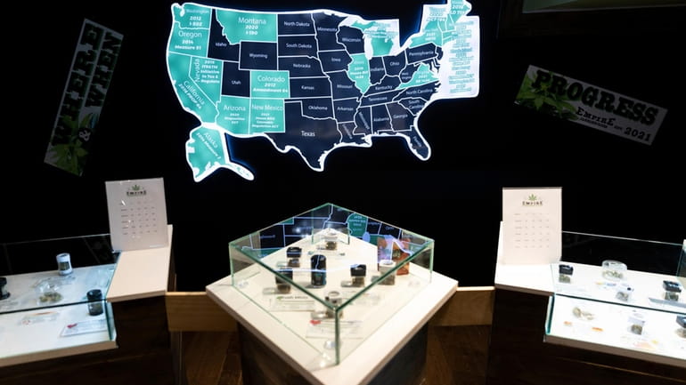A map of cannabis legalization in the U.S. glows behind...