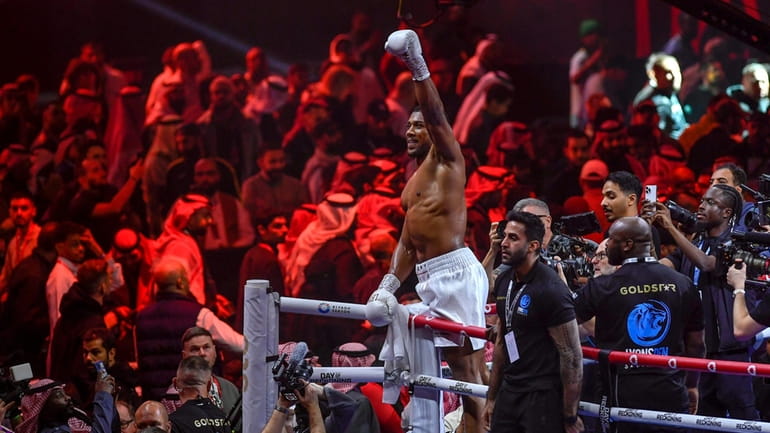 Anthony Joshua celebrates after defeating Otto Wallin in a boxing...