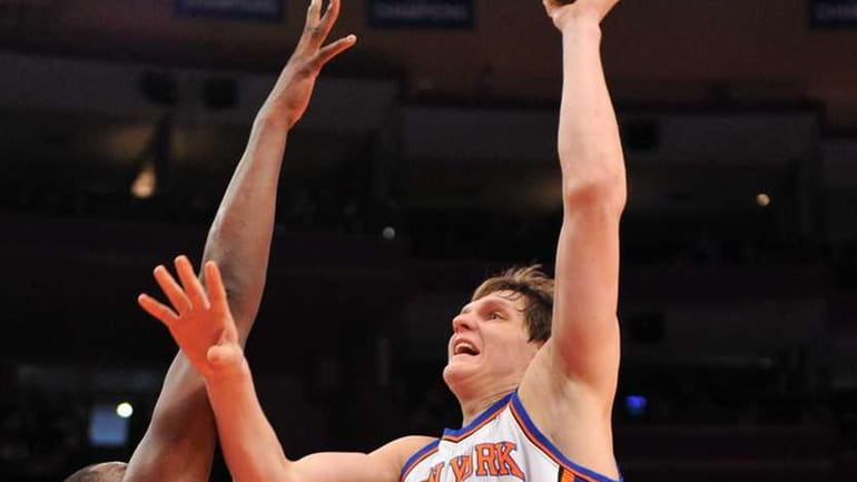 Knicks center Timofey Mozgov takes a jump shot against the...