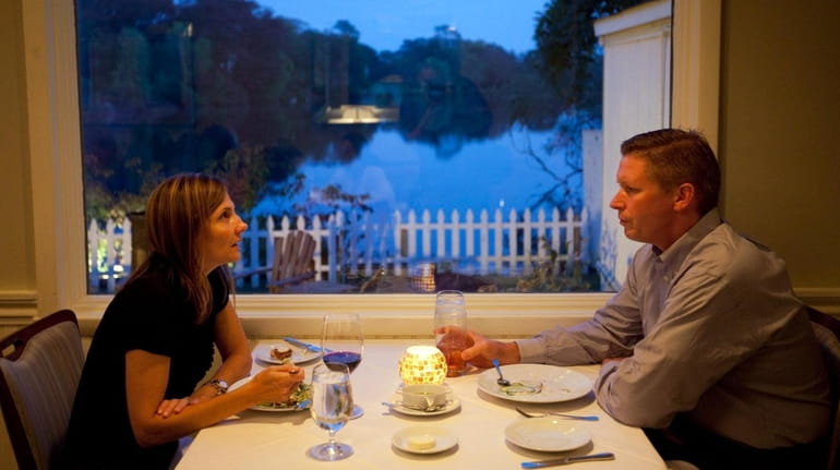 Diners share a romantic meal at The Lake House in...