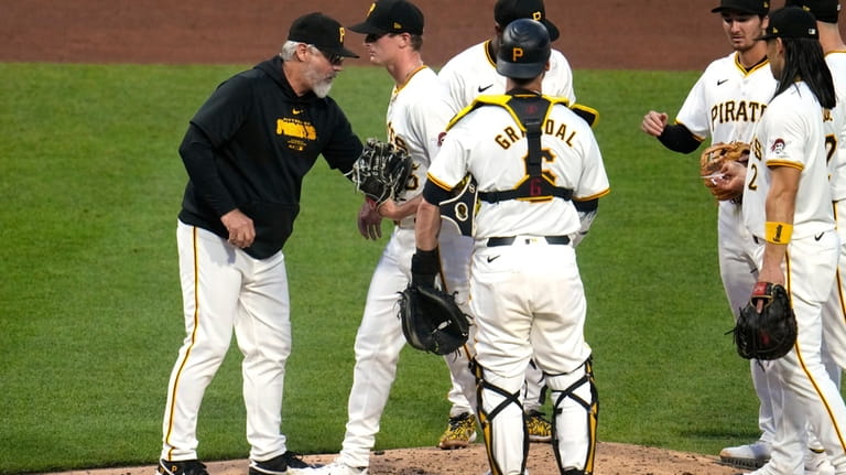 Pittsburgh Pirates pitcher Quinn Priester, second from left, walks off...