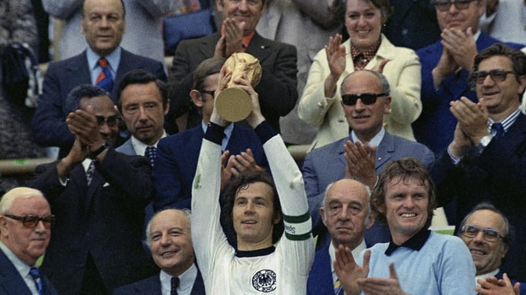 West Germany captain Franz Beckenbauer holds up the World Cup...