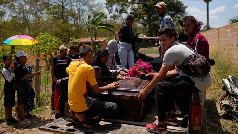 The coffin that contain the remains miner Gerson Leal, is...