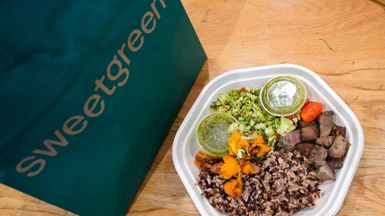 Sweetgreen's new caramelized garlic steak bowl sits on the table...