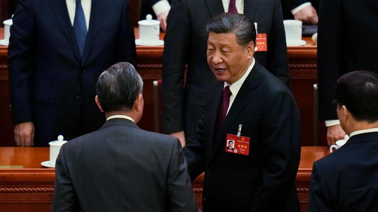 Chinese President Xi Jinping, right, chats with Foreign Minister Wang...
