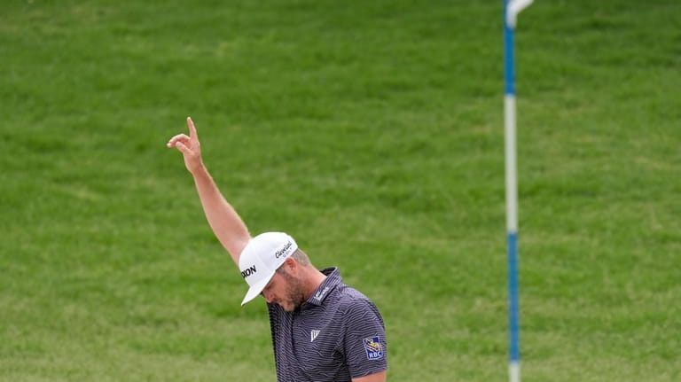Taylor Pendrith reacts after sinking a birdie from the sand...