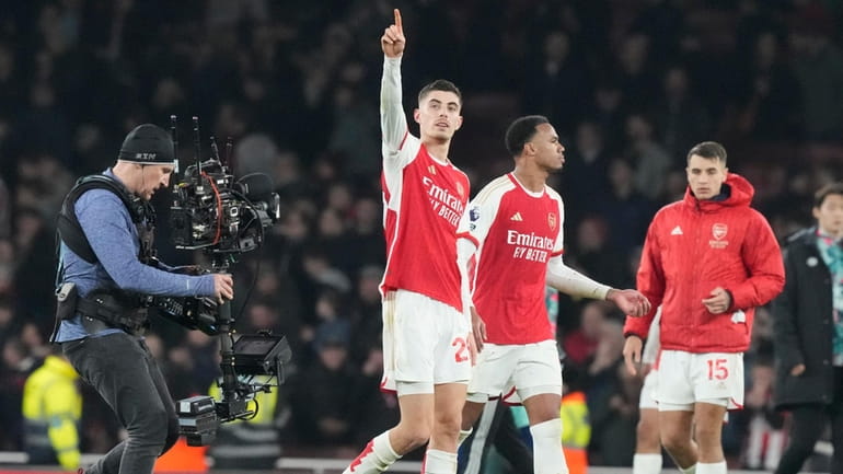 Arsenal's Kai Havertz, centre, celebrates with teammates after the English...