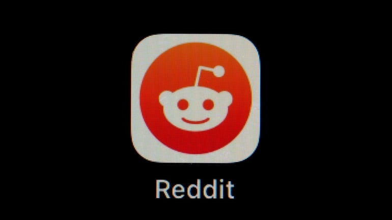 The Reddit app icon is seen on a smartphone, Feb....