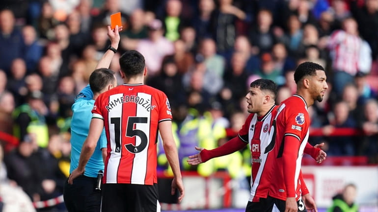 Sheffield United's Mason Holgate, second right, shown a red card...