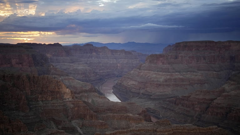 The Colorado River flows through the Grand Canyon on the...