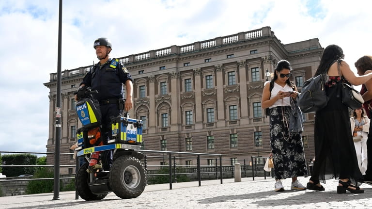 A police officer on a Segway patrols Sweden's parliament Riksdagen...