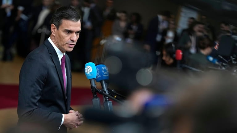 Spain's Prime Minister Pedro Sanchez speaks with the media as...