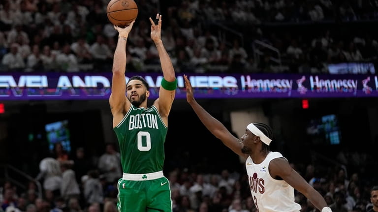 Boston Celtics forward Jayson Tatum (0) shoots in front of...