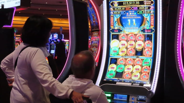 A gambler plays a slot machine at the Ocean Casino...