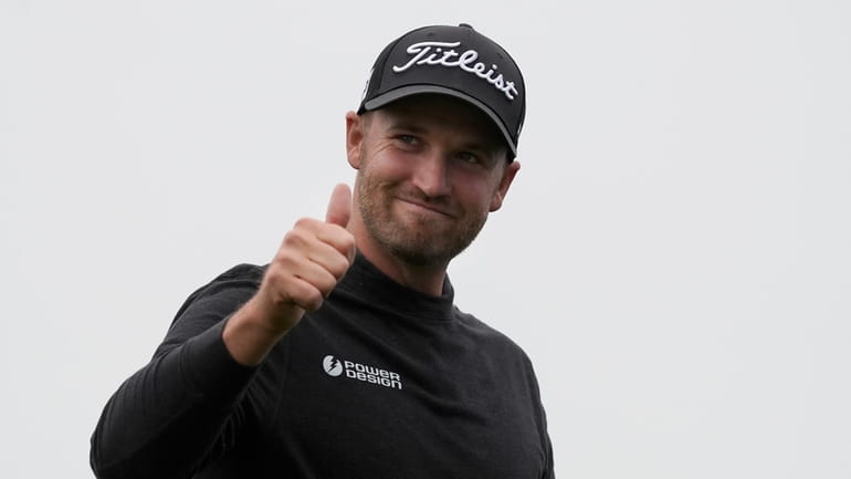 Wyndham Clark gestures after finishing the 18th hole at Pebble...