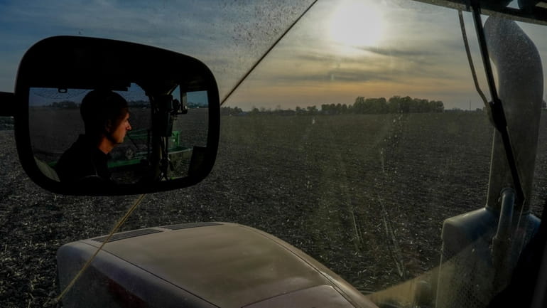Mark Woodruff operates a planter in a soybean field, Monday,...