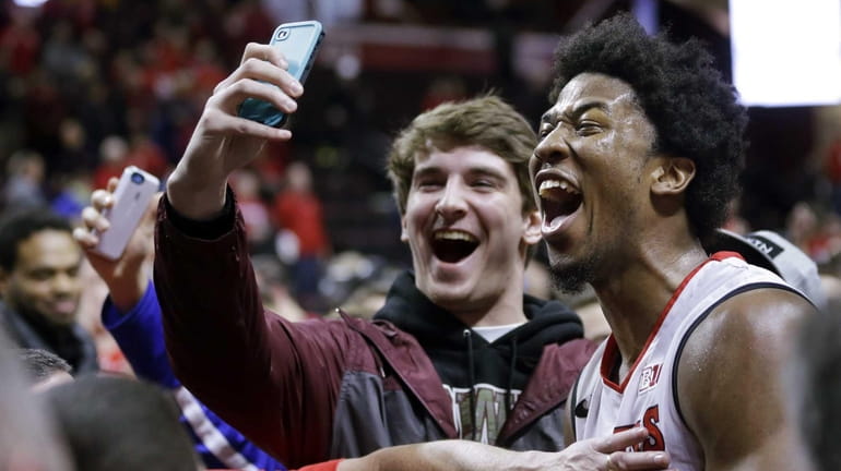 Rutgers forward Kadeem Jack, right, poses for a selfie with...