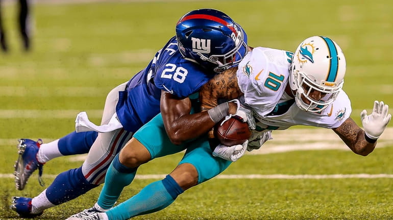 Eli Apple of the Giants takes Kenny Stills of the...