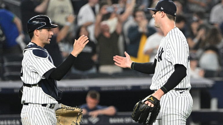 New York Yankees relief pitcher Clay Holmes, right, celebrates