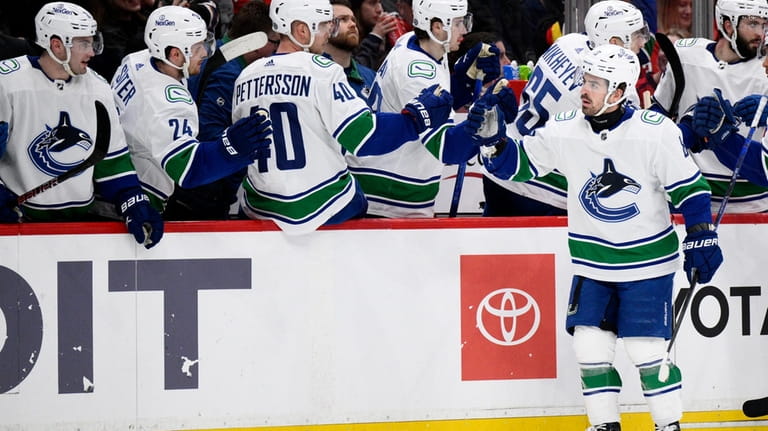 Vancouver Canucks right wing Conor Garland (8) celebrates his goal...