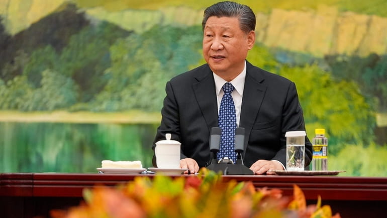 Chinese President Xi Jinping talks to U.S. Secretary of State...