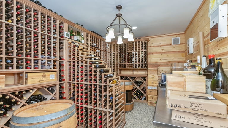 The wine cellar holds 2,000 bottles and is climate-controlled, the listing...