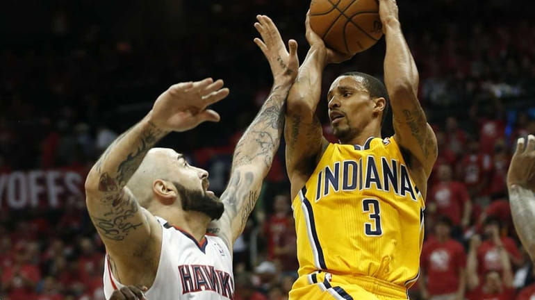 Indiana Pacers guard George Hill passes as Atlanta Hawks center...