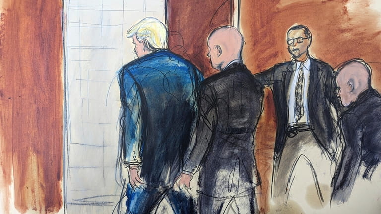 In this courtroom sketch, former President Donald Trump, left, is...