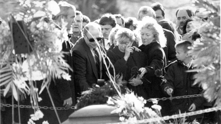Carolyn McCarthy wipes a tear at a graveside service at the...