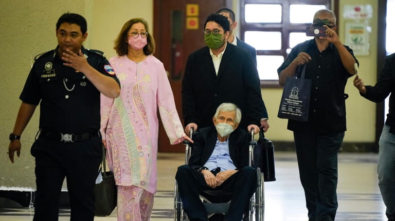 Former Malaysian Finance Minister Daim Zainuddin on wheelchair leaves the...