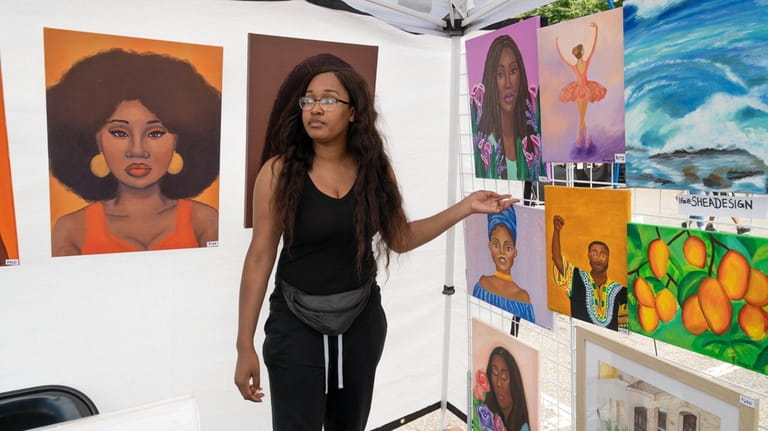 Sheniqua Young, a painter and digital illustrator, displays her work at...