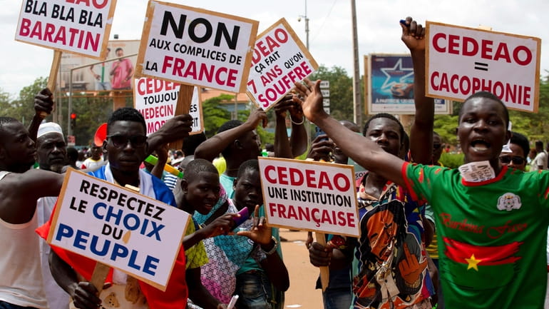 Supporters of Capt. Ibrahim Traore protest against France and the...