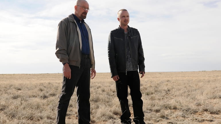 Bryan Cranston as Walter White, left, and Aaron Paul as...