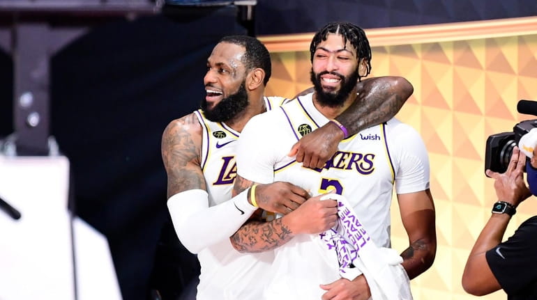LeBron James and Anthony Davis of the Los Angeles Lakers react...