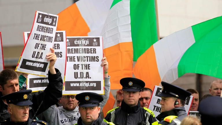 Irish police stand in front of supporters of the anti-British...