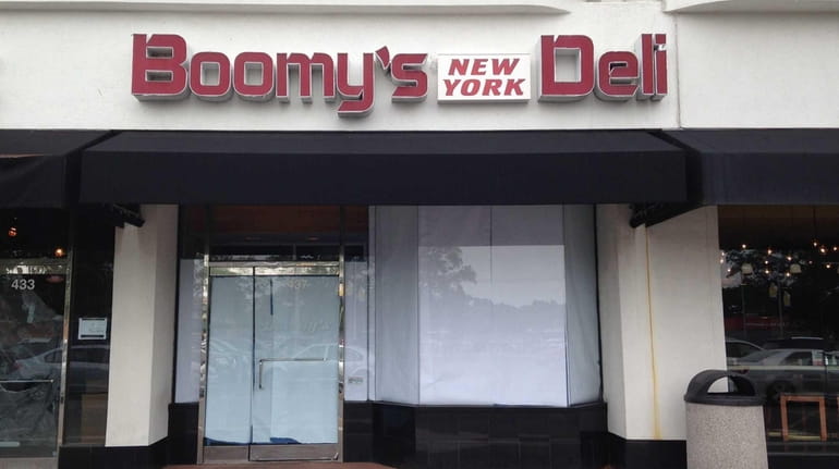 The windows are papered over at Boomy's New York Deli...