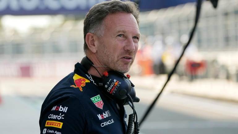 Red Bull team principal Christian Horner walks from the garage...